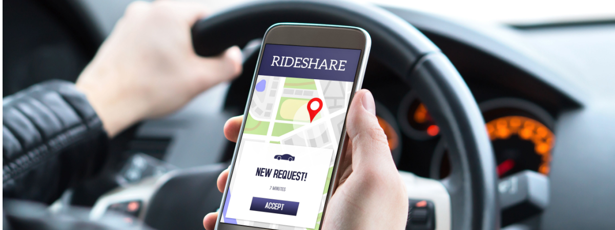 Ride share driver in car using the rideshare app in mobile phone-Shutterstock_1158247045